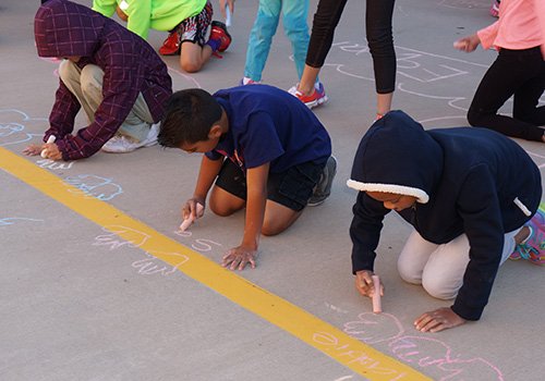 Students Trace Hands in Chalk Students Trace Hands in Chalk
